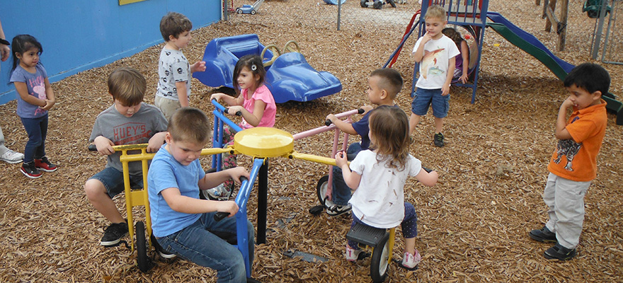 Children playing together on outdoor playground equipment.